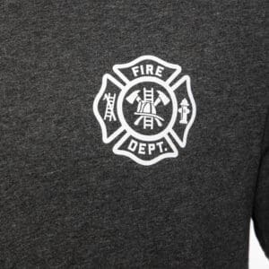 Fire department emblem on dark fabric shirt.