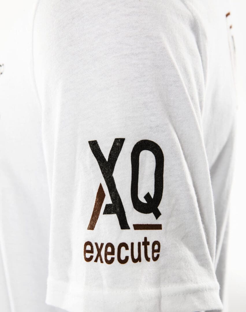 White shirt with "XQ execute" text on sleeve.