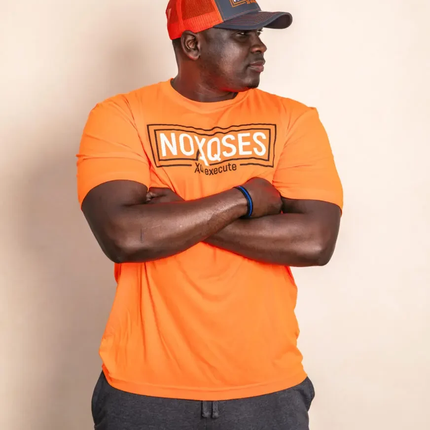 Man in orange shirt and cap.